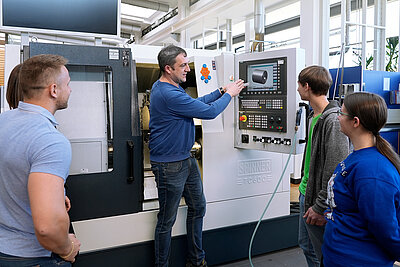 Teacher and students in a lab