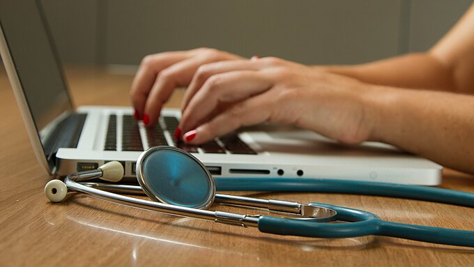 Hands on a laptop keyboard