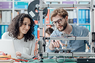 Female and male student working together on an engineeirng project