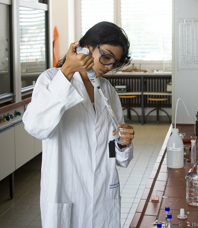 Young international student working in a texile lab