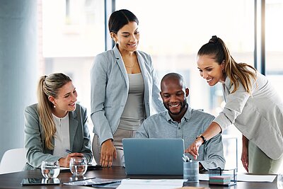 Group of young professionals happily discussing a project