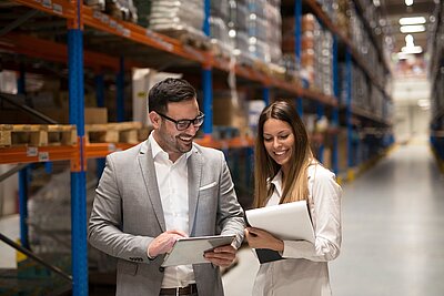 Two professionals discussing in a warehouse